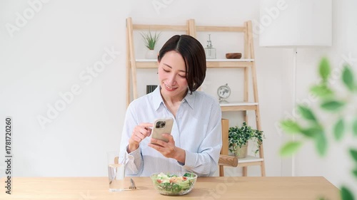 スマホで料理の写真を撮る女性