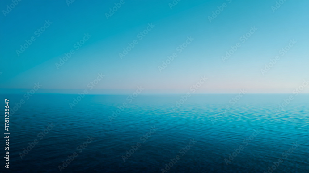 Obraz premium A serene view of the ocean meeting the sky with a gradient of blue and white colors in the horizon
