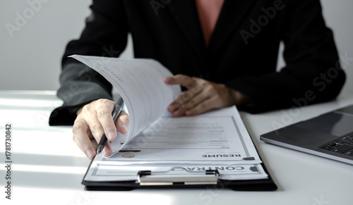 Business woman employer holding resume hiring recruit looking cv resume to hire candidates, analyzing information before job interview. Recruitment concepts