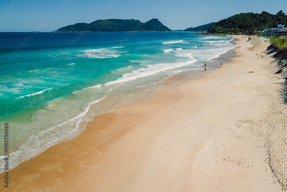 Fototapeta premium Beach and blue ocean with waves in Brazil. Aerial view of Morro das Pedras