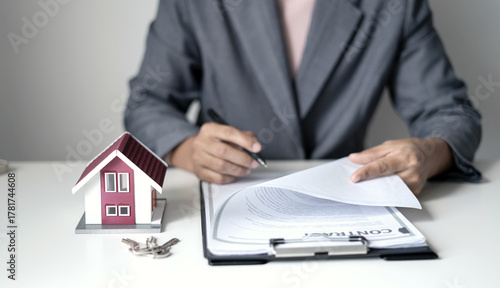 home dealer businessman signing home insurance document or lease paper. home loan and insurance concept