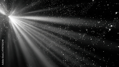 Dramatic abstract light beam cutting through dark black space. Mysterious glimmering ray illuminating floating dust particle on background