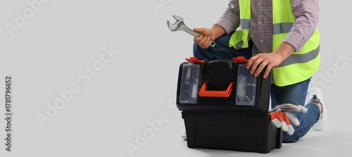 Male worker with tools box ...