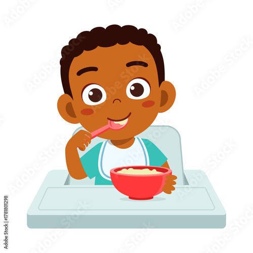 African American Little Boy Eating Cereal Smiling Sitting on Baby Chair at Home