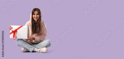 Young woman with laptop as ...