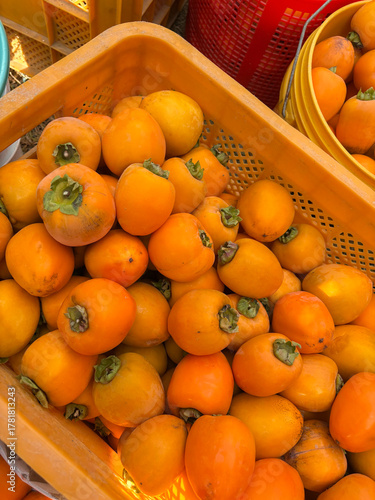 shot of ripe persimmon fruits stacked together.