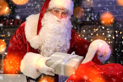 Santa Claus putting Christm...