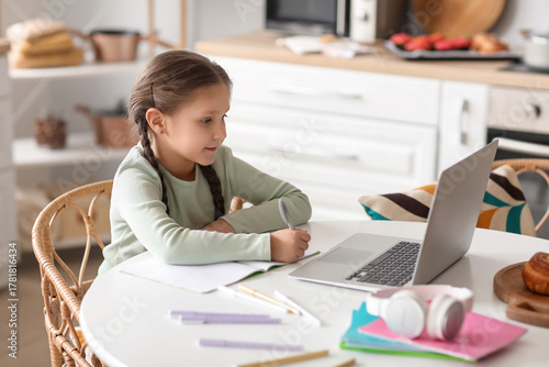 Little girl with laptop stu...