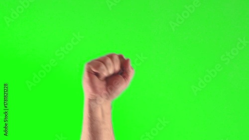 Man's clenched fist symbolizing protest against injustice on a vibrant green background