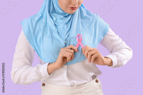 Young Muslim woman with pin...
