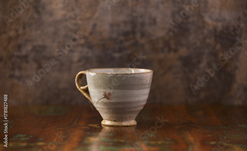 Traditional, handcrafted ceramic on wooden background.	Soft focus. Copy space. 