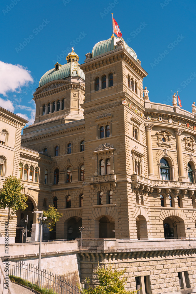 Fototapeta premium Bundeshaus federal palace in bern switzerland with flag