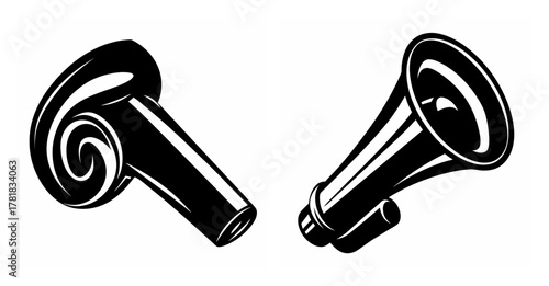 Two classic black party blowers one unrolled and one a megaphone for festive celebration sounds