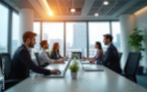 Blurred background of a modern office interior with blurred business people working in a team at a table. High quality