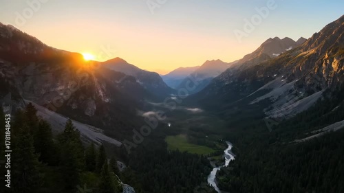 Aerial drone view flying over majestic mountain range and serene valley at golden sunrise majestic mountain range, dawn, beautiful