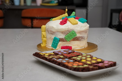 Closeup of childs birthday cake and chocolate cookies on the table