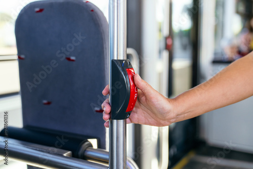 Photos Hand pressing the red stop request button on a pole inside a public city bus, in