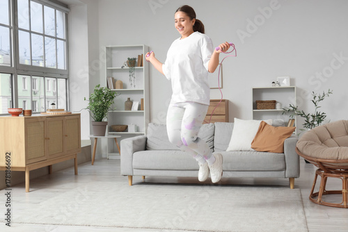 Sporty young woman jumping ...