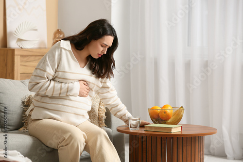 Young pregnant woman suffer...