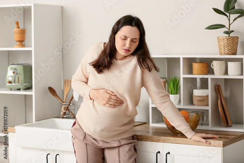 Young pregnant woman suffer...