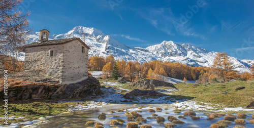 little chapel in  village le Monal in scenic nature  in alpine valley with go...