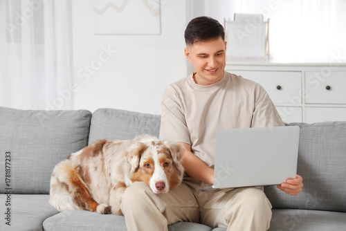 Young man with modern lapto...