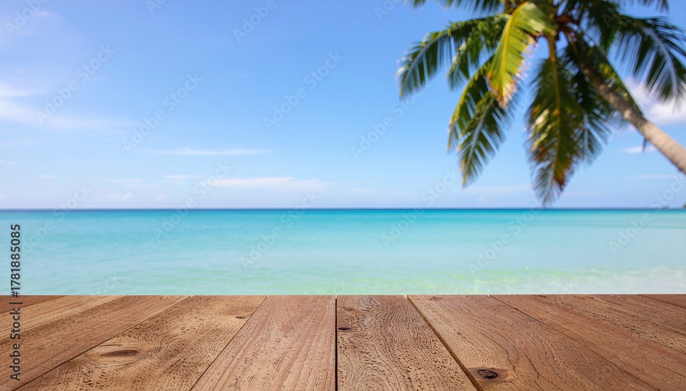Fototapeta premium Wooden table top overlooking sparkling turquoise sea water with swaying coconut palm tree and clear blue sky background. Perfect tropical summer vacation banner concept