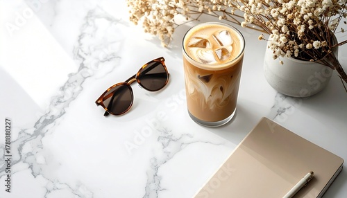 A high-angle flat lay of an iced Latte (visible beautiful layers) on a clean white