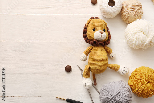 Knitted lion toy with yarn,...