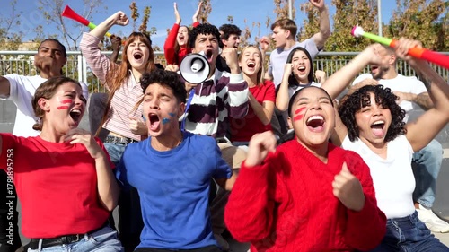 Enthusiastic sports fans cheering and celebrating victory in stadium bleachers