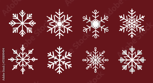 Collection of eight intricate white snowflake designs on a deep red background.