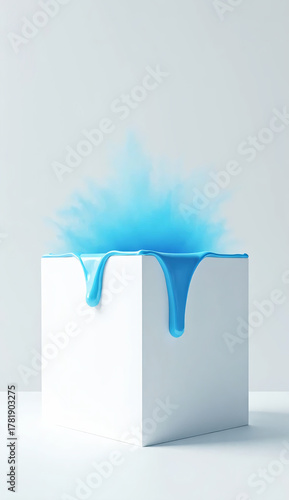 pure white cube on a neutral light grey background with glossy blue paint dripping gently on the top edge of the cube