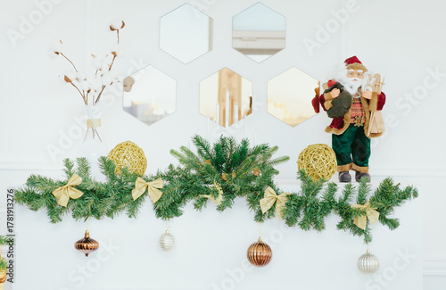 Holiday background. Christmas decorations in white interior. Close up. Light Christmas wallpaper.