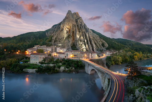 Sisteron village houses illuminated under Rocher de la Baume