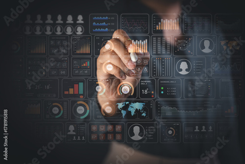 Hand with stylus interacting with multiple holographic dashboards for real time data analytics business monitoring and decision making