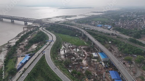 Evening view of Patna Marine Drive with JP Ganga Setu stretching across the Ganges in Bihar, India. A blend of modern infrastructure and riverside beauty, capturing city life, skyline, and tranquil wa