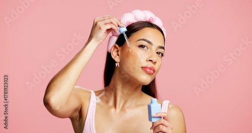 Photography Portrait, apply serum and woman in studio for skincare, beauty treatment and product for healthy glow