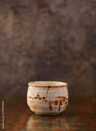 Traditional, handcrafted ceramic on wooden background. Soft focus. Copy space.