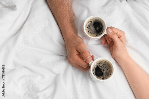 Young couple with cups of c...