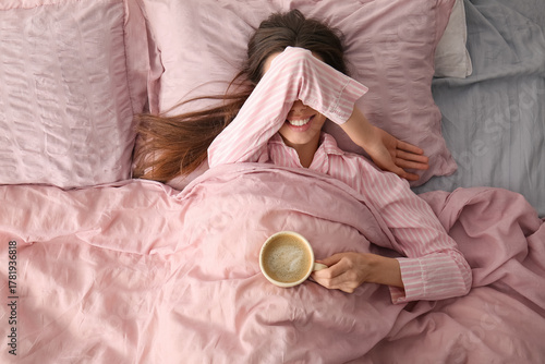 Happy young woman with cup ...