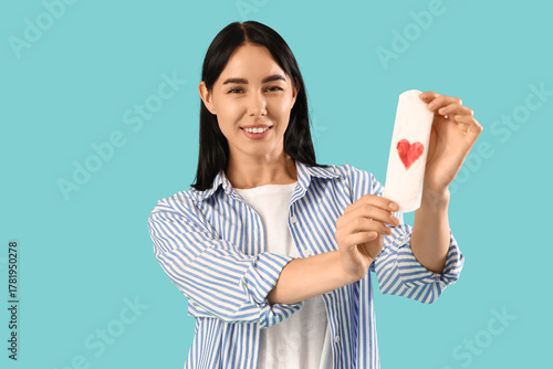 Young woman holding menstru...