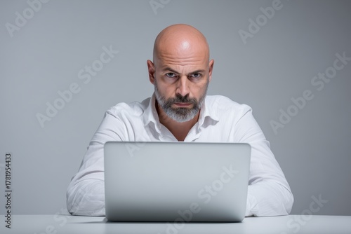 Business Tech Professional Working Intently on Laptop Minimalist Office Setting Focused Environment Documentary Style