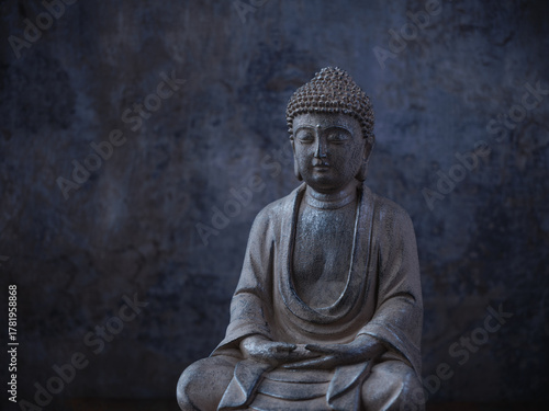 Meditating Buddha Statue on dark background. Soft focus. Close up. Copy space	