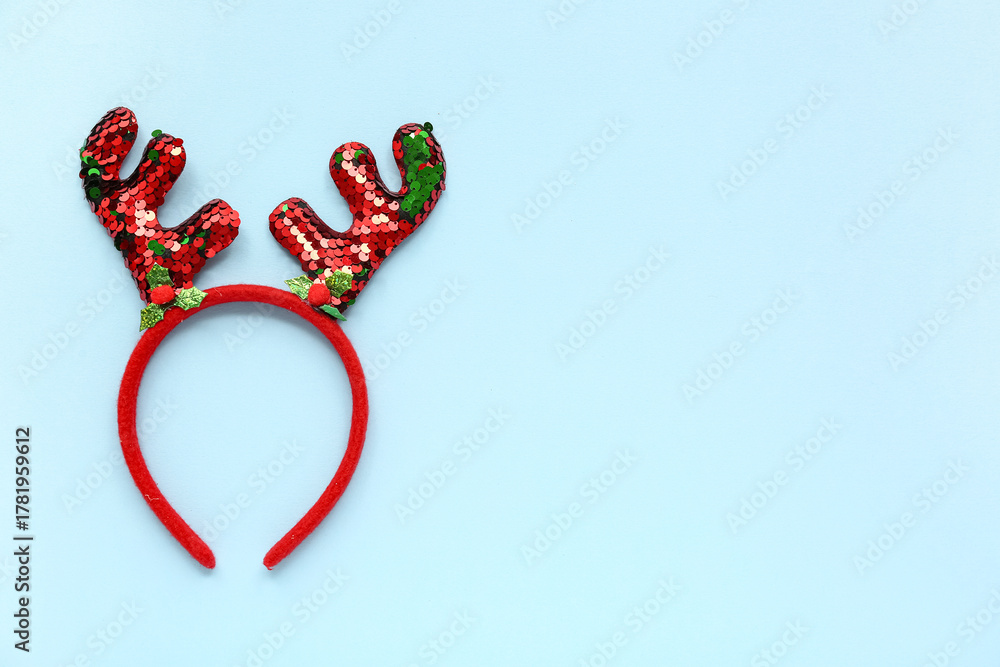 Obraz premium Christmas reindeer antlers headband on blue background