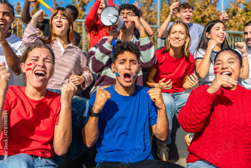 Cheering fans celebrating a sports victory in stadium