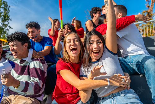 Young friends cheering and celebrating at stadium event