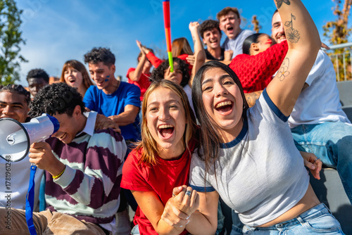 Fotografía Young friends cheering at sports event celebrating victory