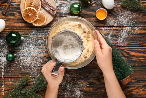 Young woman pouring flour i...