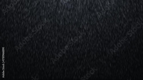 Dark realistic rain falling on a black background. Seamless loop animation of heavy rainfall, perfect for weather effects, cinematic scenes, mood backgrounds, and atmospheric visual projects.