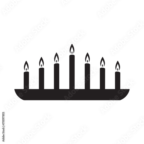 Silhouette of a candelabra with seven lit candles on a white background